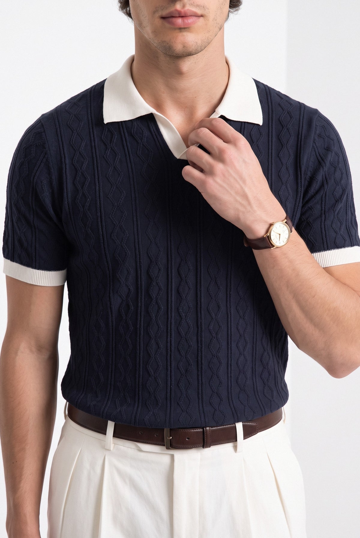 Men's diamond knit polo in navy and white, close-up detail