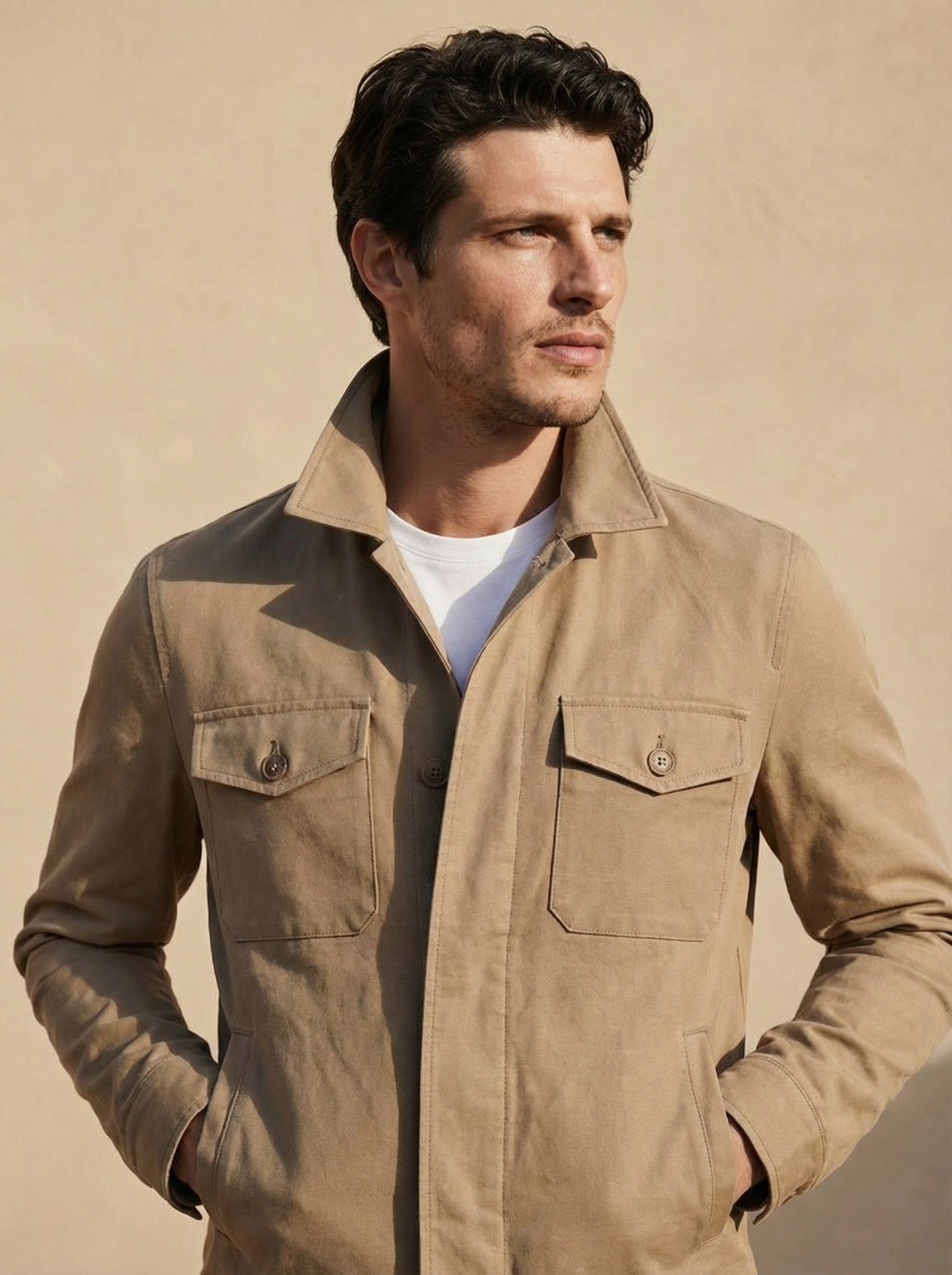 Man wearing a beige jacket against a beige background