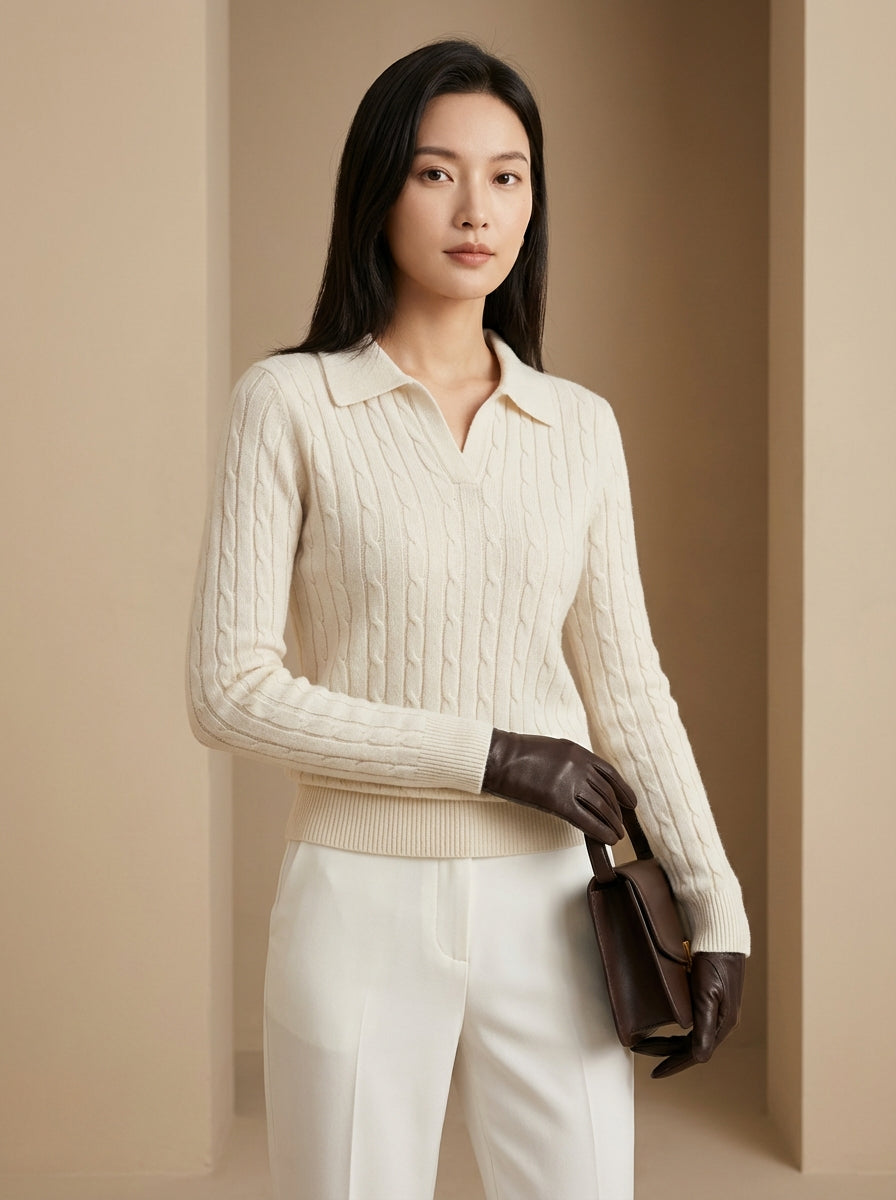 Woman wearing a cream sweater and white pants with brown gloves against a beige background
