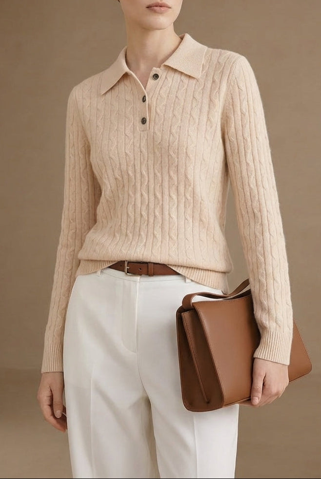 Woman wearing a beige ribbed sweater and white pants, holding a brown leather bag against a beige background.