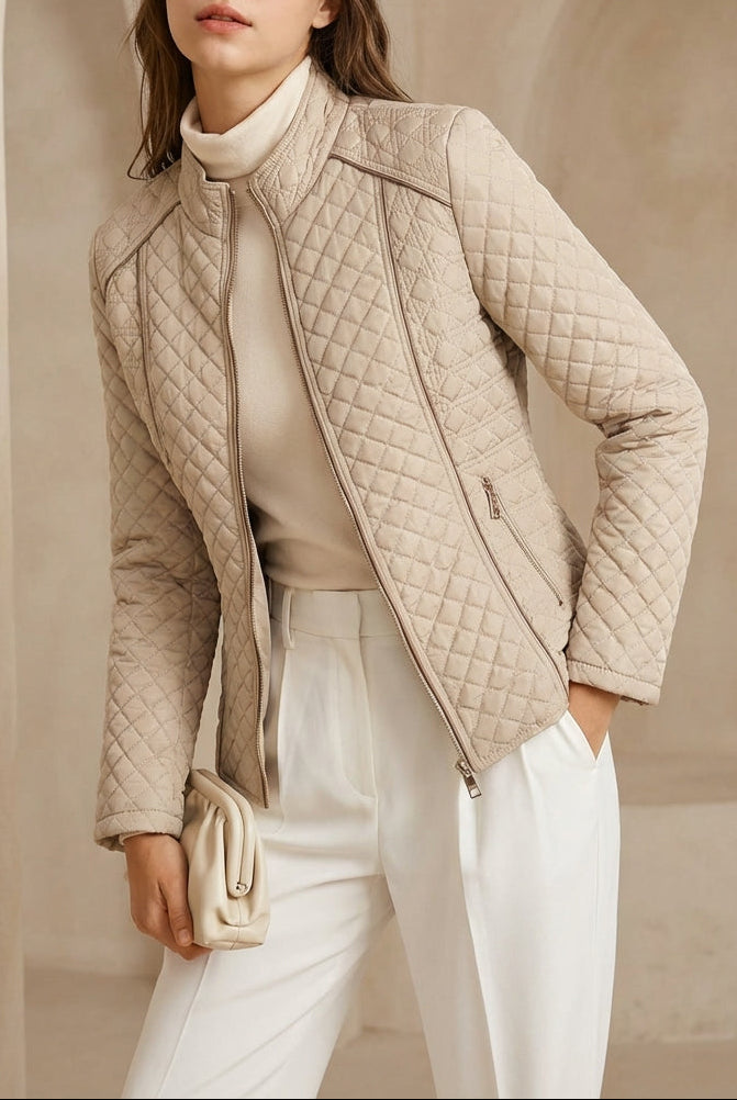 Woman wearing a beige quilted jacket in an elegant interior setting