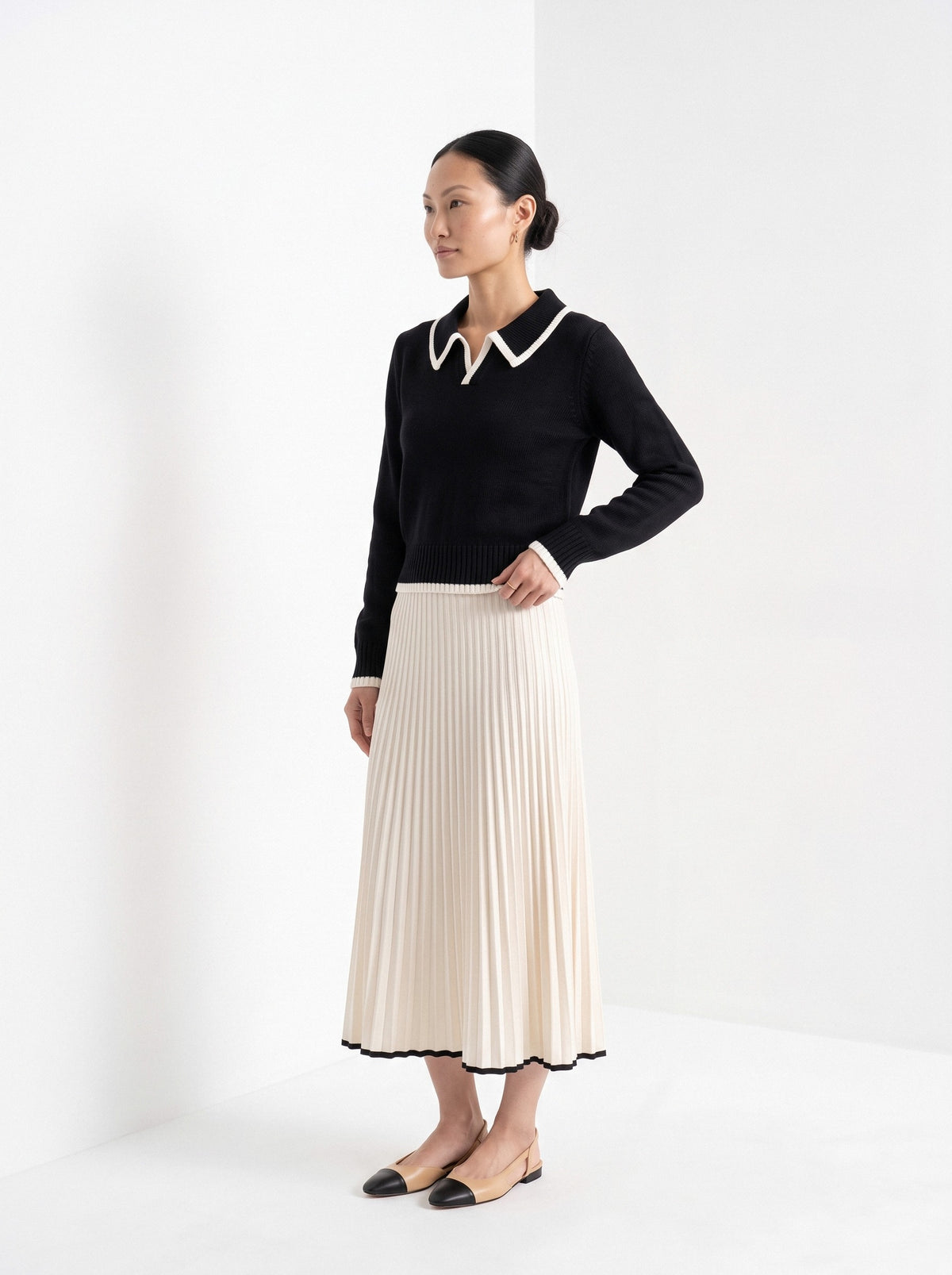 BLENIN piped collar sweater in black, three-quarter view