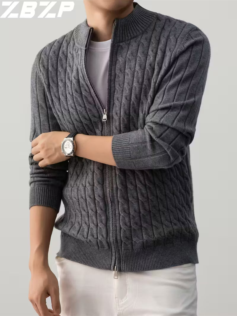 Person wearing a gray cable knit sweater with a zipper on a light gray background