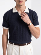Men's diamond knit polo in navy and white, close-up detail