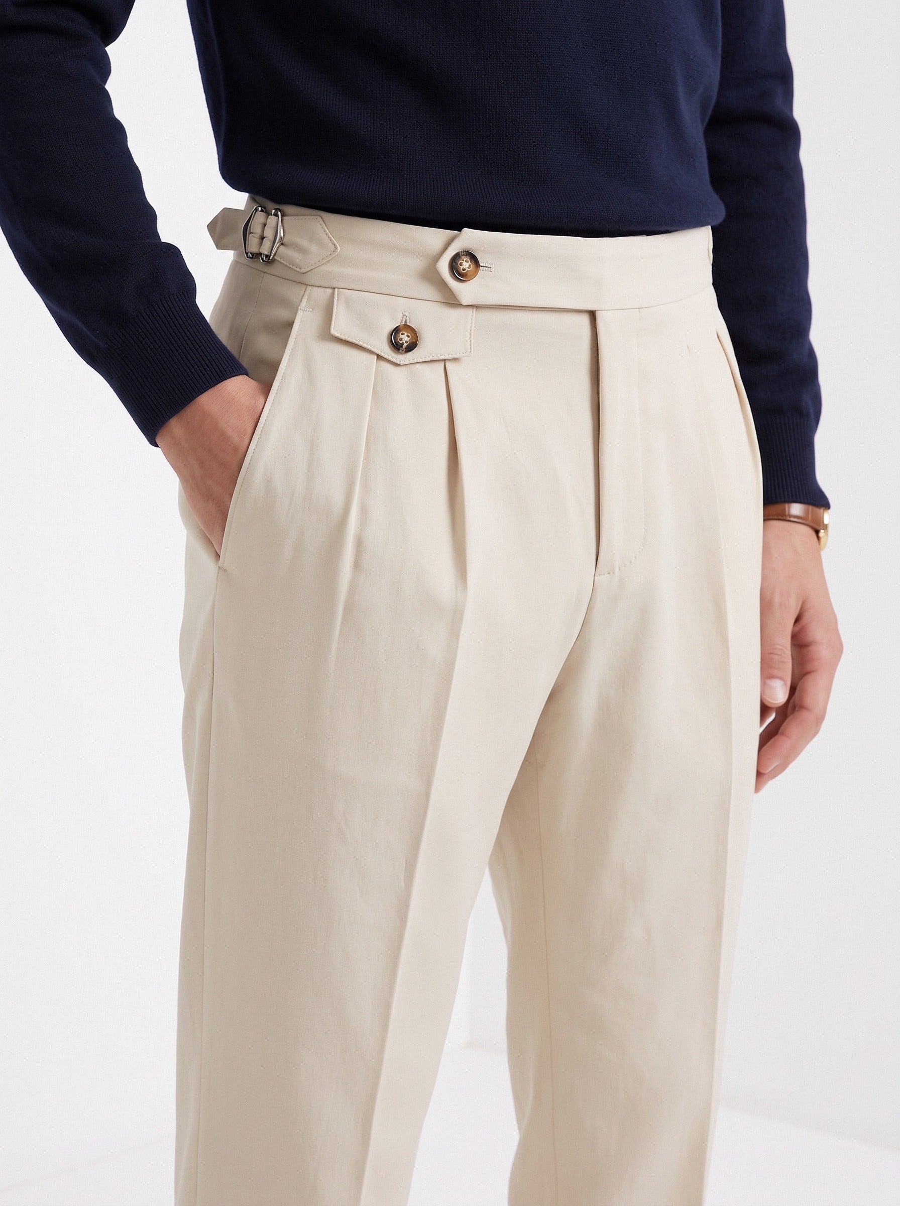 Men's high waisted trousers in beige, close-up detail