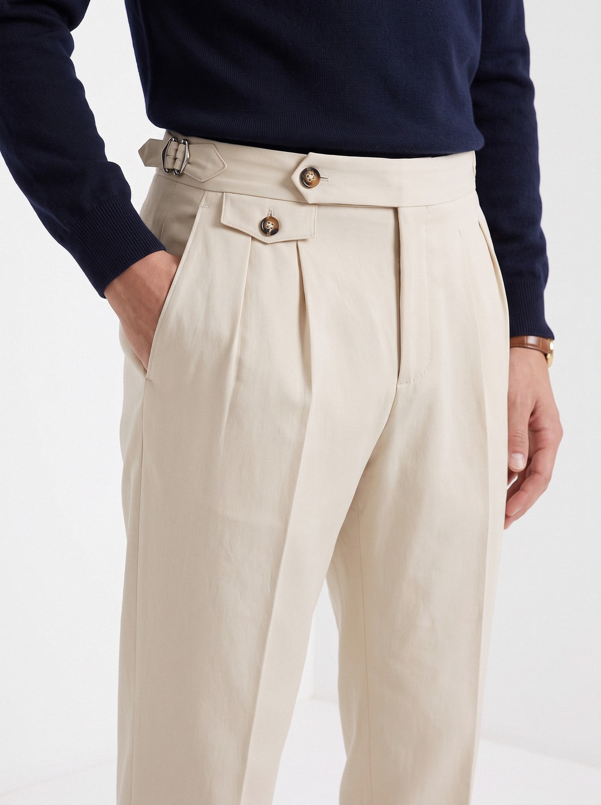 Men's high waisted trousers in beige, close-up detail