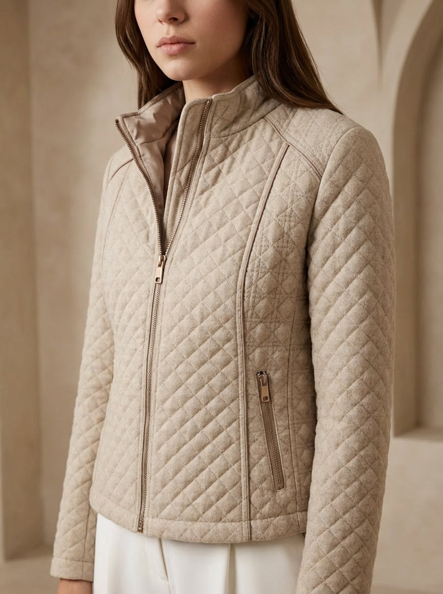 Beige quilted jacket worn by a person against a neutral background