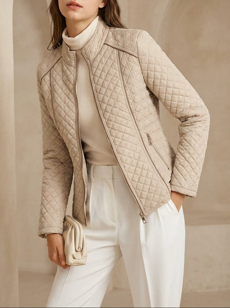 Woman wearing a beige quilted jacket in an elegant interior setting