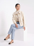 BLENIN short collared jacket in cream, seated, full outfit