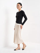 BLENIN gold button knit top in black, full-length front view