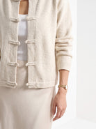 BLENIN knot button cardigan in cream, fit detail at the hem and cuff