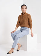 BLENIN cable button collar sweater in cognac, seated, full outfit