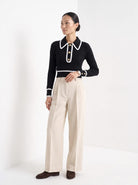BLENIN contrast collar button sweater in black, three-quarter view