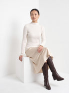 BLENIN cashmere mock neck sweater in milky, seated, full outfit