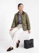 BLENIN quilted corduroy collar jacket in olive, seated, full outfit