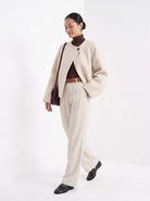 BLENIN collarless short coat in cream, full outfit, walking