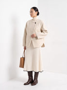 BLENIN collarless short coat in cream, three-quarter view