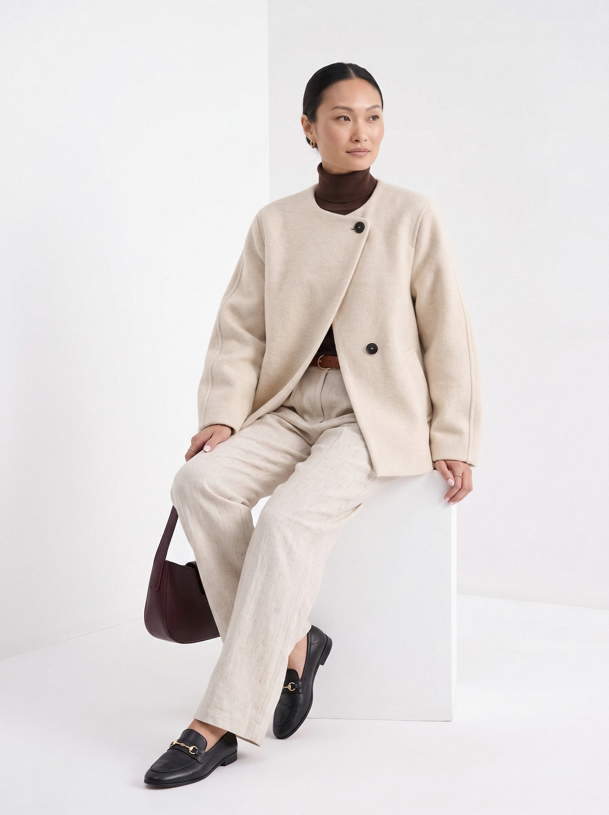 BLENIN collarless short coat in cream, seated, full outfit