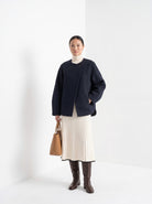 BLENIN collarless short coat in navy, full-length front view